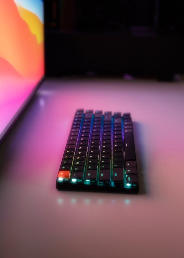 A sleek RGB keyboard on a desk with vibrant, colorful lighting. Perfect for tech enthusiasts.